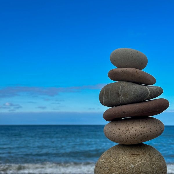 A balanced stack of stones on a serene background, representing philosophy.